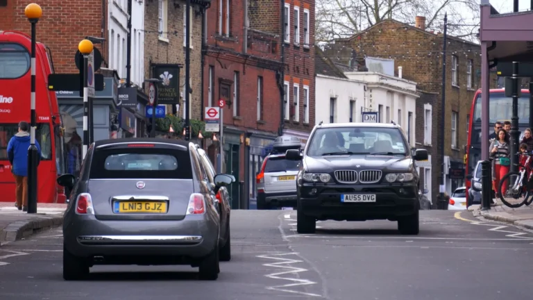 Cars and traffic on a busy UK town street, the kind of road conditions you drive in on a practical test